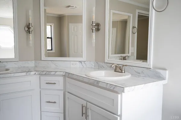 a room with a white bed and a window