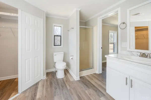 a view of an empty room with wooden floor