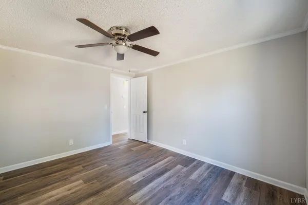 a view of a room with wooden floor and white walls