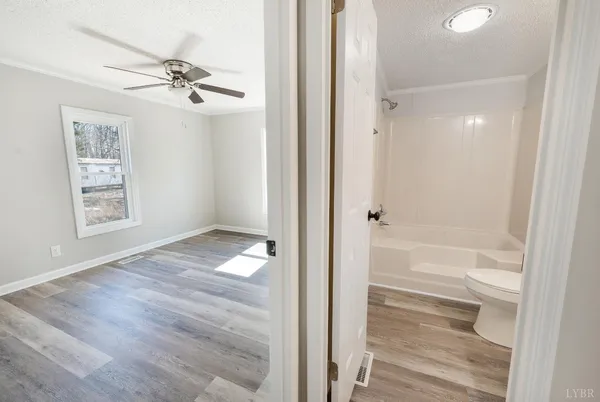 a view of house with backyard and trees