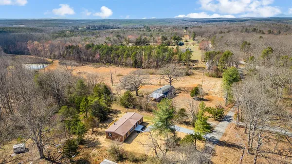 a view of an empty room with windows and closet