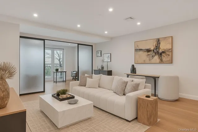a living room with furniture rug and wall painting