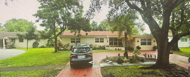 a front view of a house with a yard table and chairs