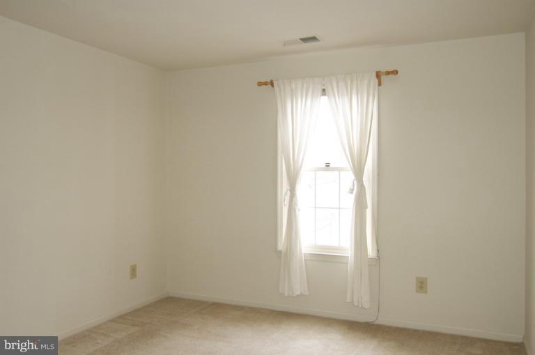 10703 Kings Riding Way, Unit 20113 Rockville, MD 20852 - Photo 13 of 17 a view of an empty room and window