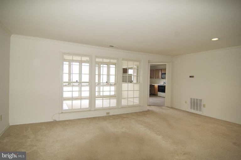 10703 Kings Riding Way, Unit 20113 Rockville, MD 20852 - Photo 7 of 17 an empty room with windows