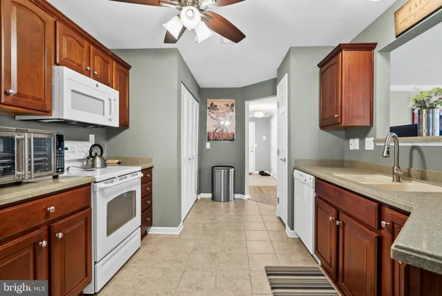 a kitchen with stainless steel appliances granite countertop a sink and cabinets