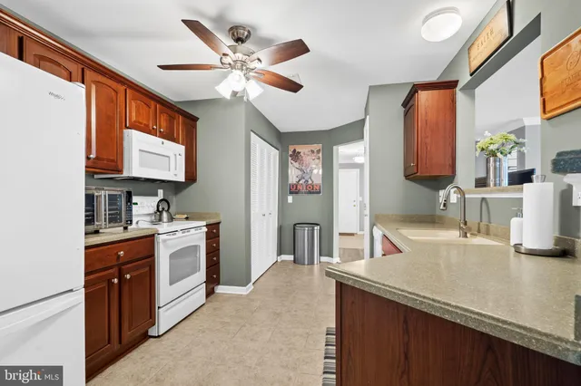 a kitchen with stainless steel appliances granite countertop a sink and a stove