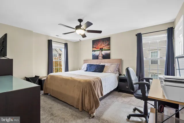 a bedroom with a bed and a desk