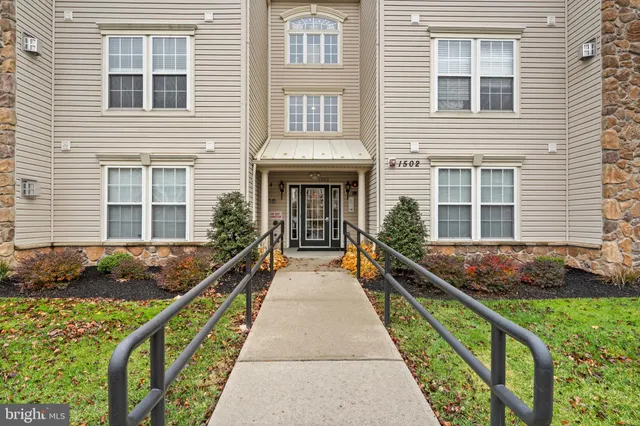 a view of house with pool and wooden bench