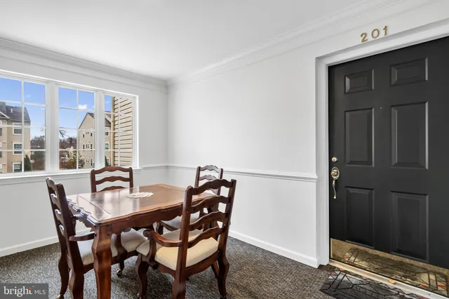 a view of a dining room with furniture and window