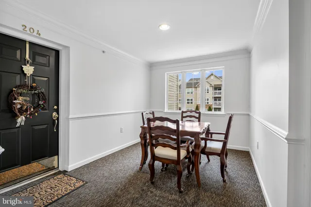 a view of a dining room with furniture and window