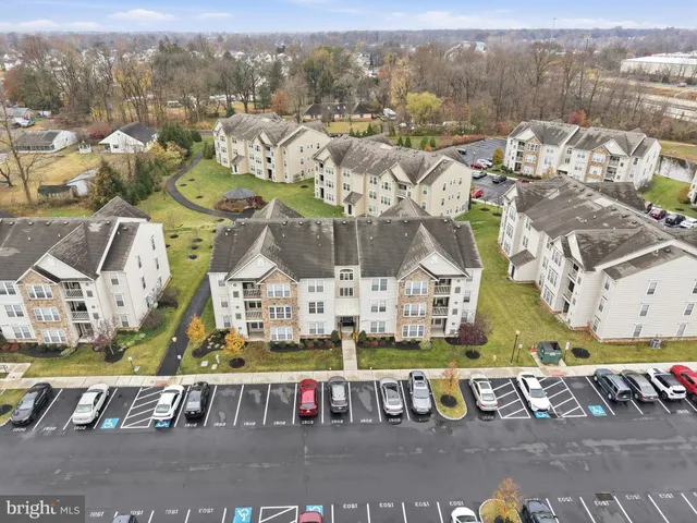an aerial view of residential building and car parked