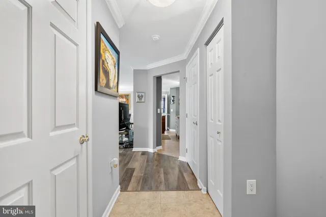 a view of a hallway with wooden floor and entryway
