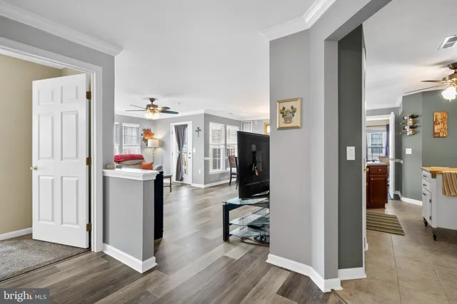 a view of a hallway with workspace and living room