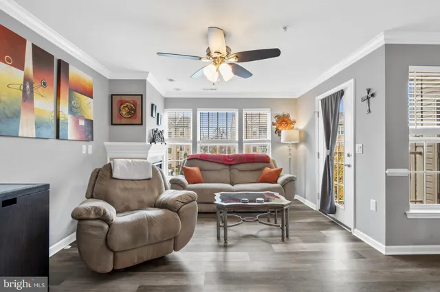 a living room with furniture a ceiling fan and a window