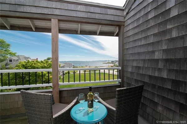 a balcony with table and chairs