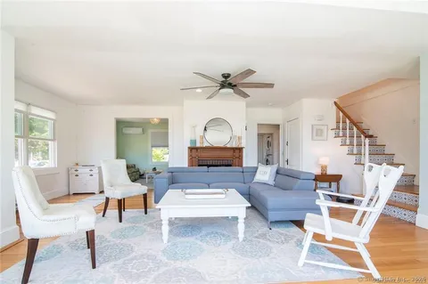 a living room with furniture a rug and a window