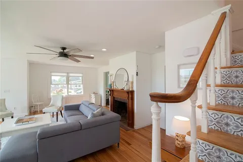 a living room with furniture a fireplace and a window