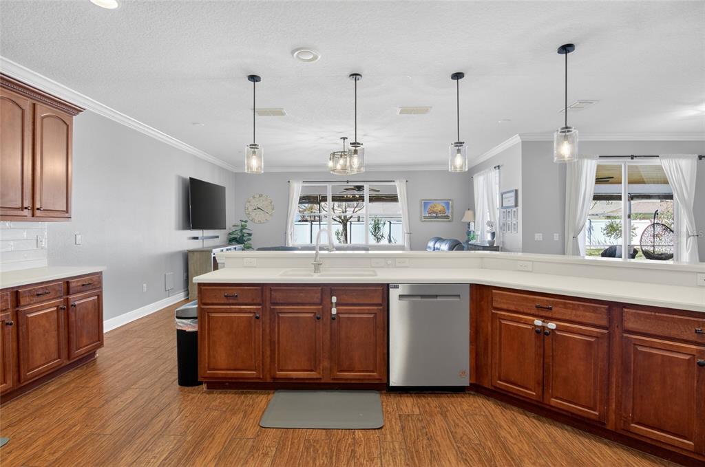 650 Setting Sun Drive Winter Garden, FL 34787 - Photo 11 of 60 a kitchen with stainless steel appliances granite countertop wooden floors and sink