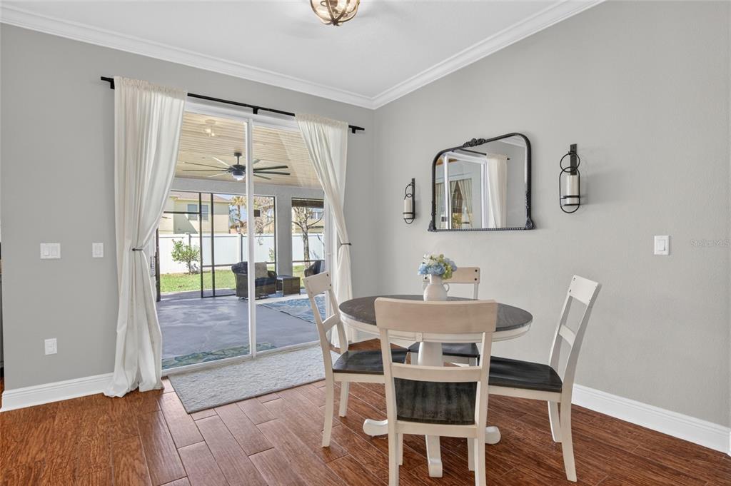 650 Setting Sun Drive Winter Garden, FL 34787 - Photo 15 of 60 a dining room with furniture and wooden floor