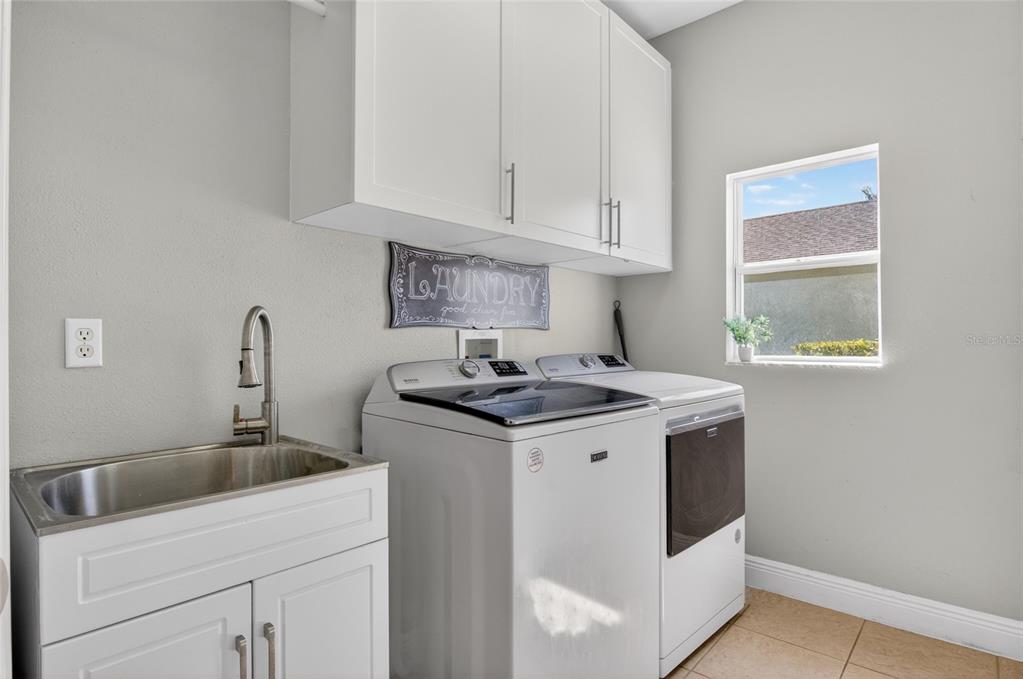 650 Setting Sun Drive Winter Garden, FL 34787 - Photo 19 of 60 a kitchen with a sink and cabinets