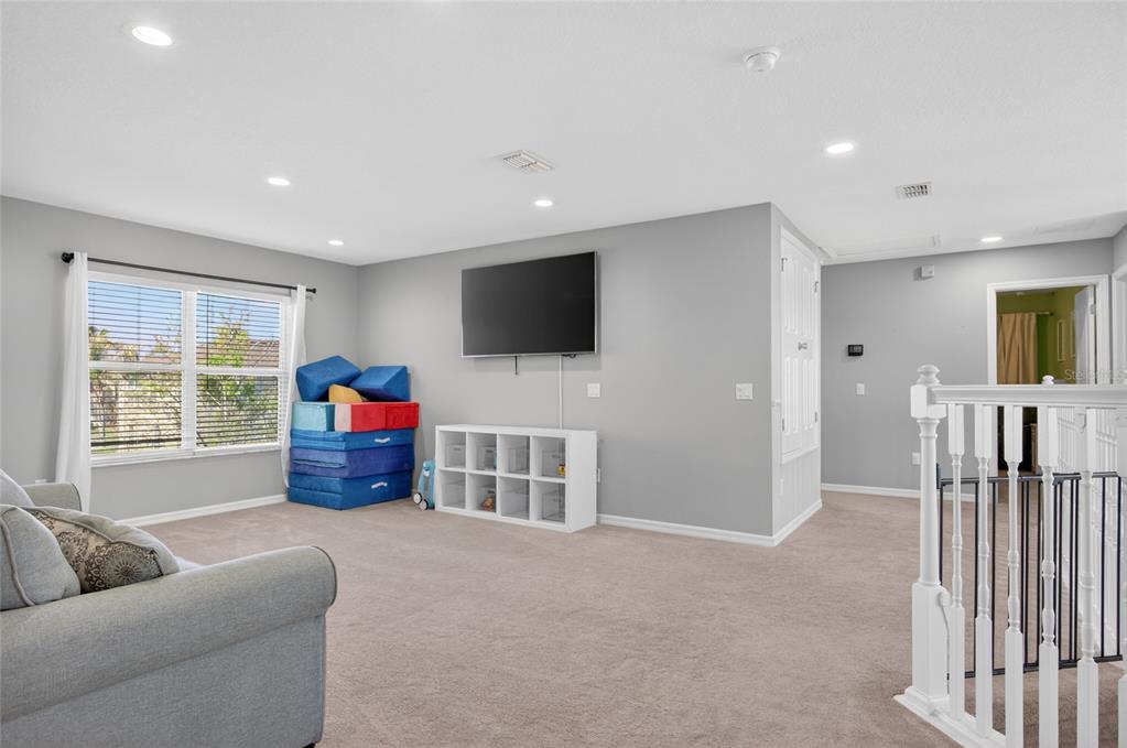 650 Setting Sun Drive Winter Garden, FL 34787 - Photo 22 of 60 a living room with furniture and a flat screen tv