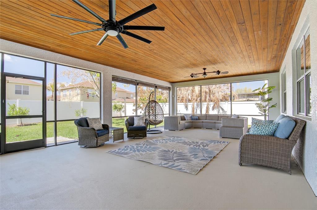 650 Setting Sun Drive Winter Garden, FL 34787 - Photo 35 of 60 a living room with furniture and a floor to ceiling window