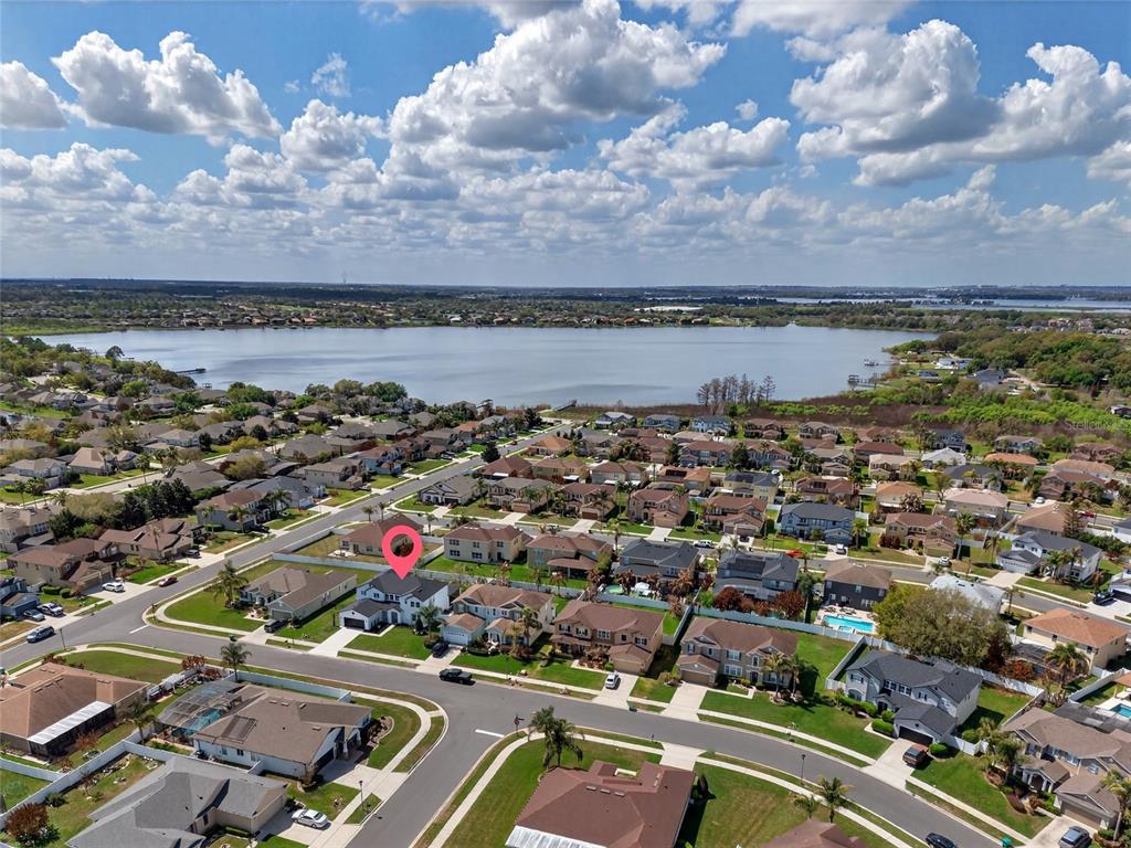 650 Setting Sun Drive Winter Garden, FL 34787 - Photo 42 of 60 an aerial view of a city with lots of residential buildings and ocean view in back