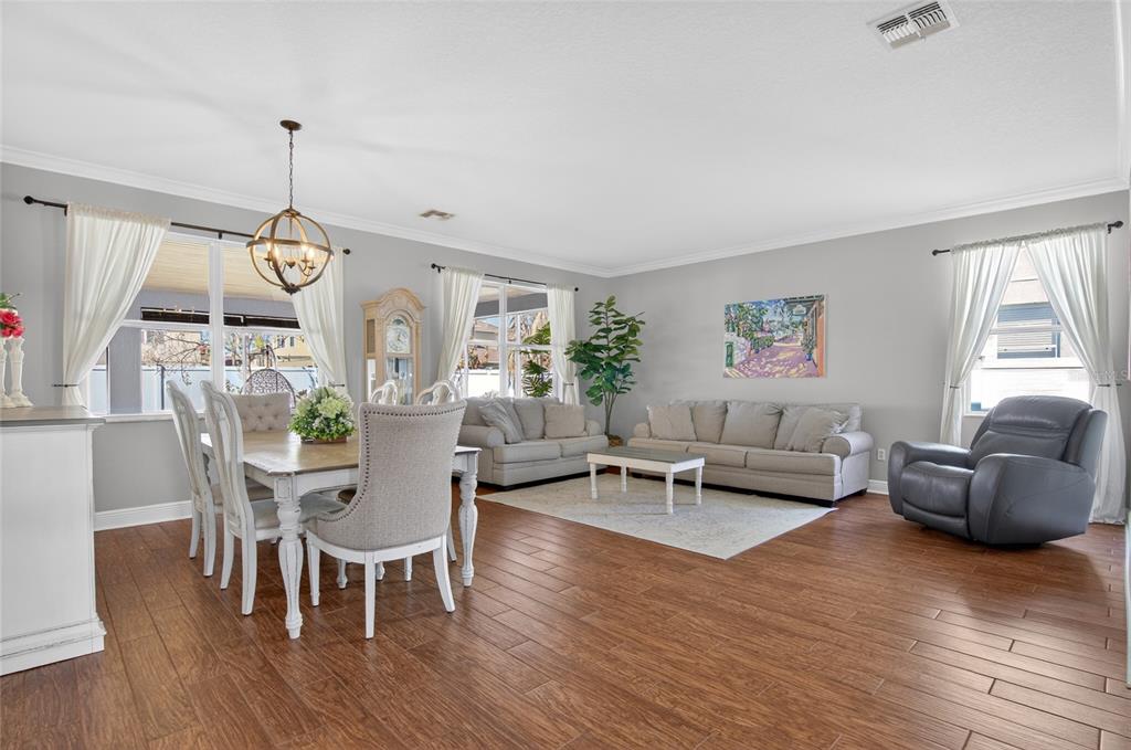 650 Setting Sun Drive Winter Garden, FL 34787 - Photo 6 of 60 a living room with furniture and a chandelier