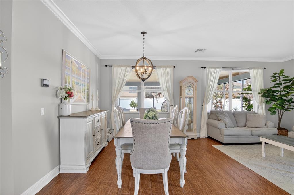 650 Setting Sun Drive Winter Garden, FL 34787 - Photo 8 of 60 a living room with kitchen island furniture and a chandelier