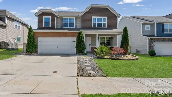 a front view of a house with a garden