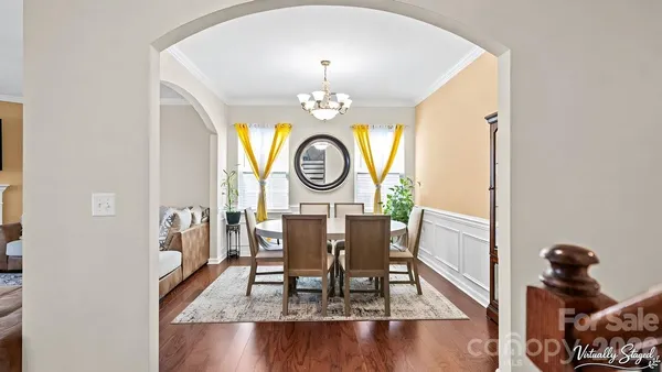 a view of a dining room with furniture and a chandelier