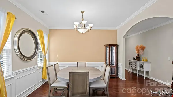 a view of a dining room with furniture and chandelier