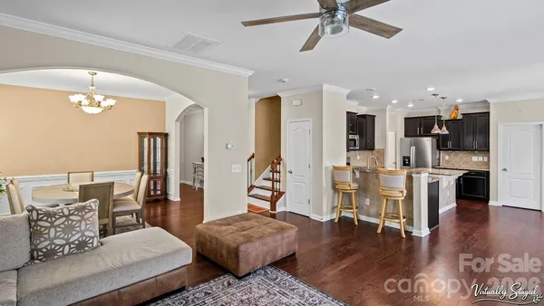 a living room with furniture and kitchen view