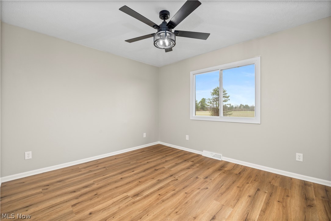 36220 Neff Road Grafton, OH 44044 - Photo 25 of 50 Empty room with wood finished floors and a ceiling fan