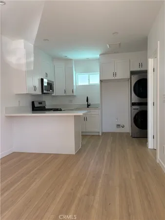 a view of a kitchen with a sink cabinets and wooden floor