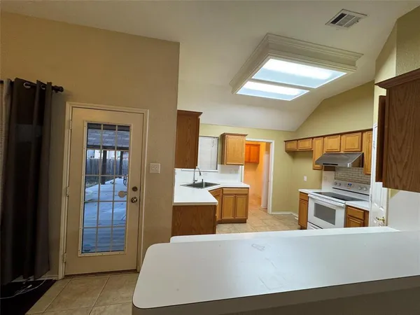 a living room with stainless steel appliances kitchen island granite countertop furniture and a large window