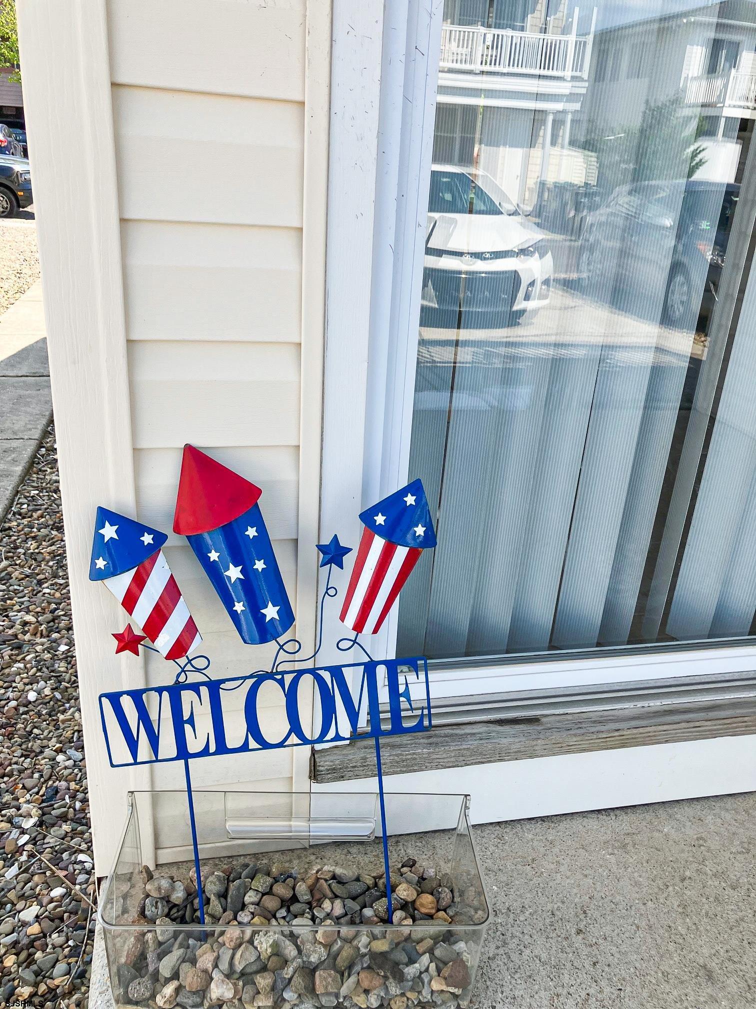 335 42nd Street South, Unit FIRST Brigantine, NJ 08203 - Photo 19 of 23 a wooden bench sitting in front of a building