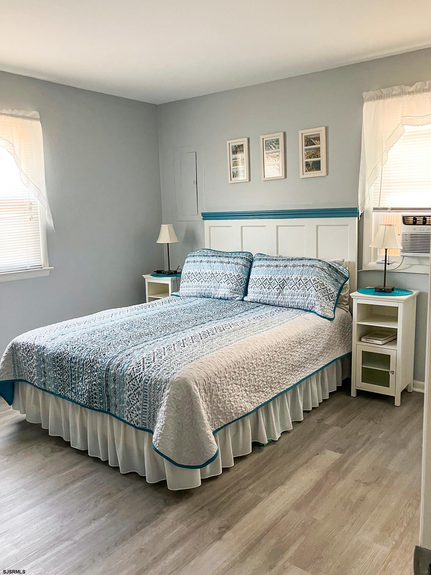 335 42nd Street South, Unit FIRST Brigantine, NJ 08203 - Photo 5 of 23 a bedroom with a bed and a night stand