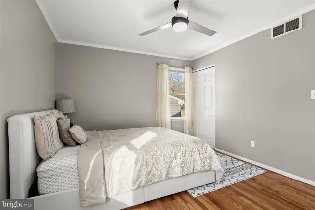 a bedroom with a large bed and a window