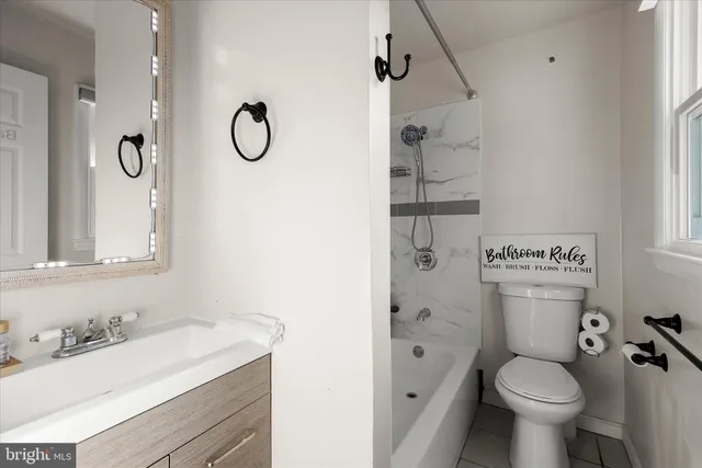 a bath room with a toilet and a bath tub