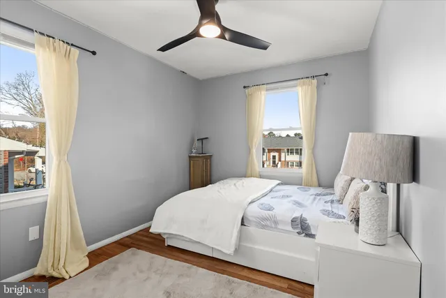 a bathroom with a toilet sink vanity and mirror