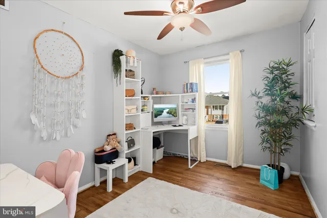 a view of a livingroom with furniture window and wooden floor