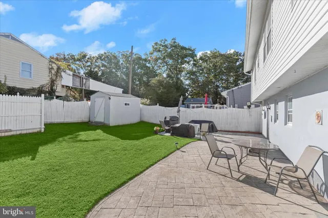 a view of a patio with table and chairs with wooden fence