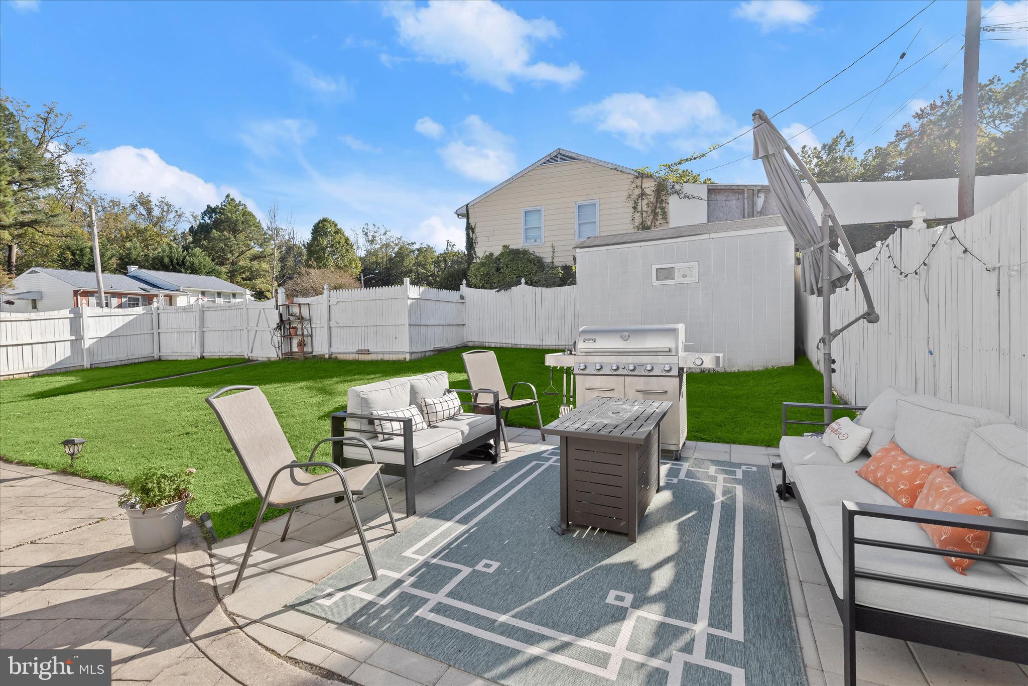 4503 Hershey Way Nottingham, MD 21236 - Photo 37 of 49 a view of a patio with couches table and chairs with wooden fence