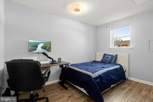 a bedroom with a bed and a desk