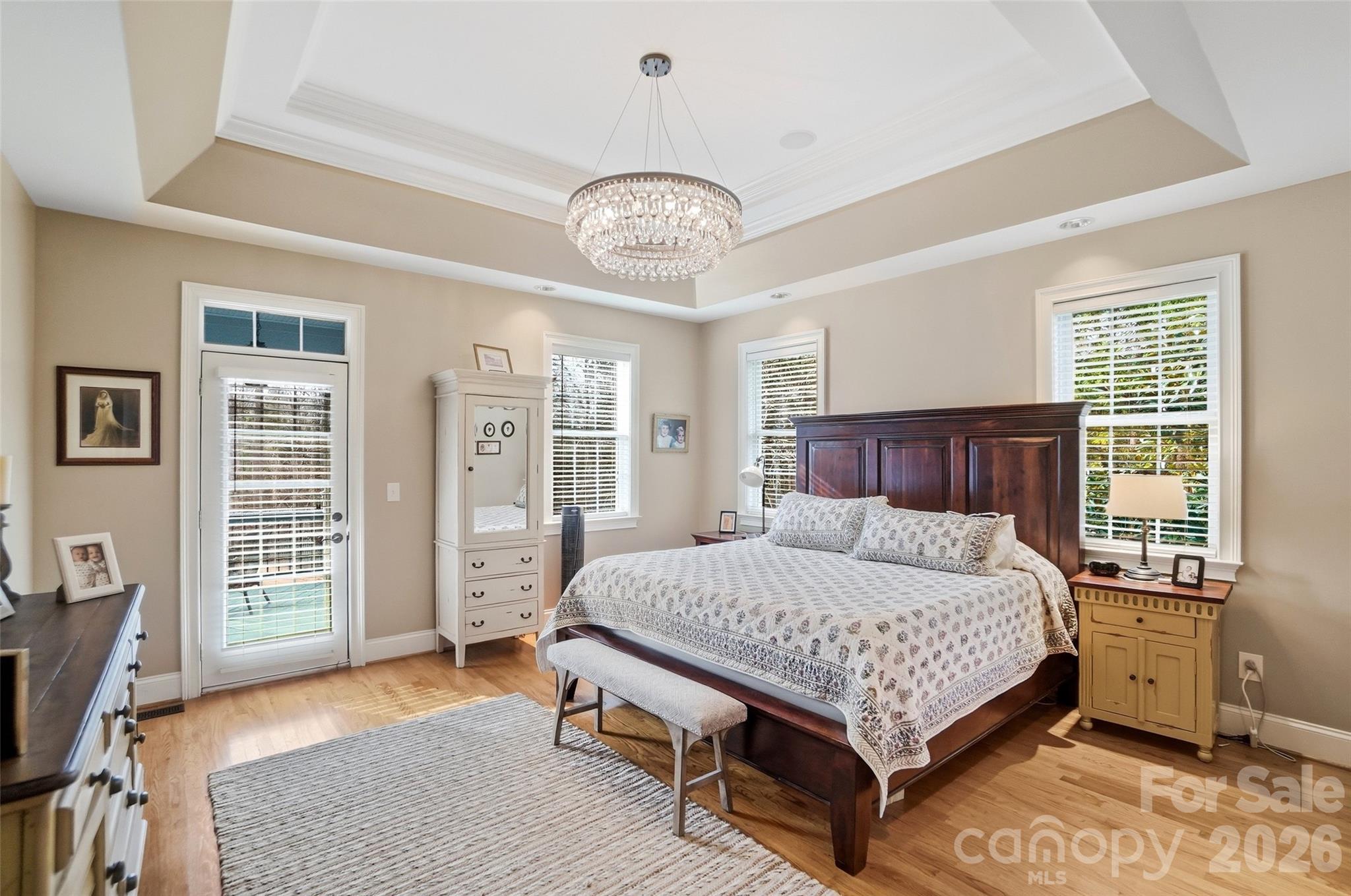 704 Mayfield Court Fort Mill, SC 29715 - Photo 23 of 48 a bedroom with a bed chandelier and a window