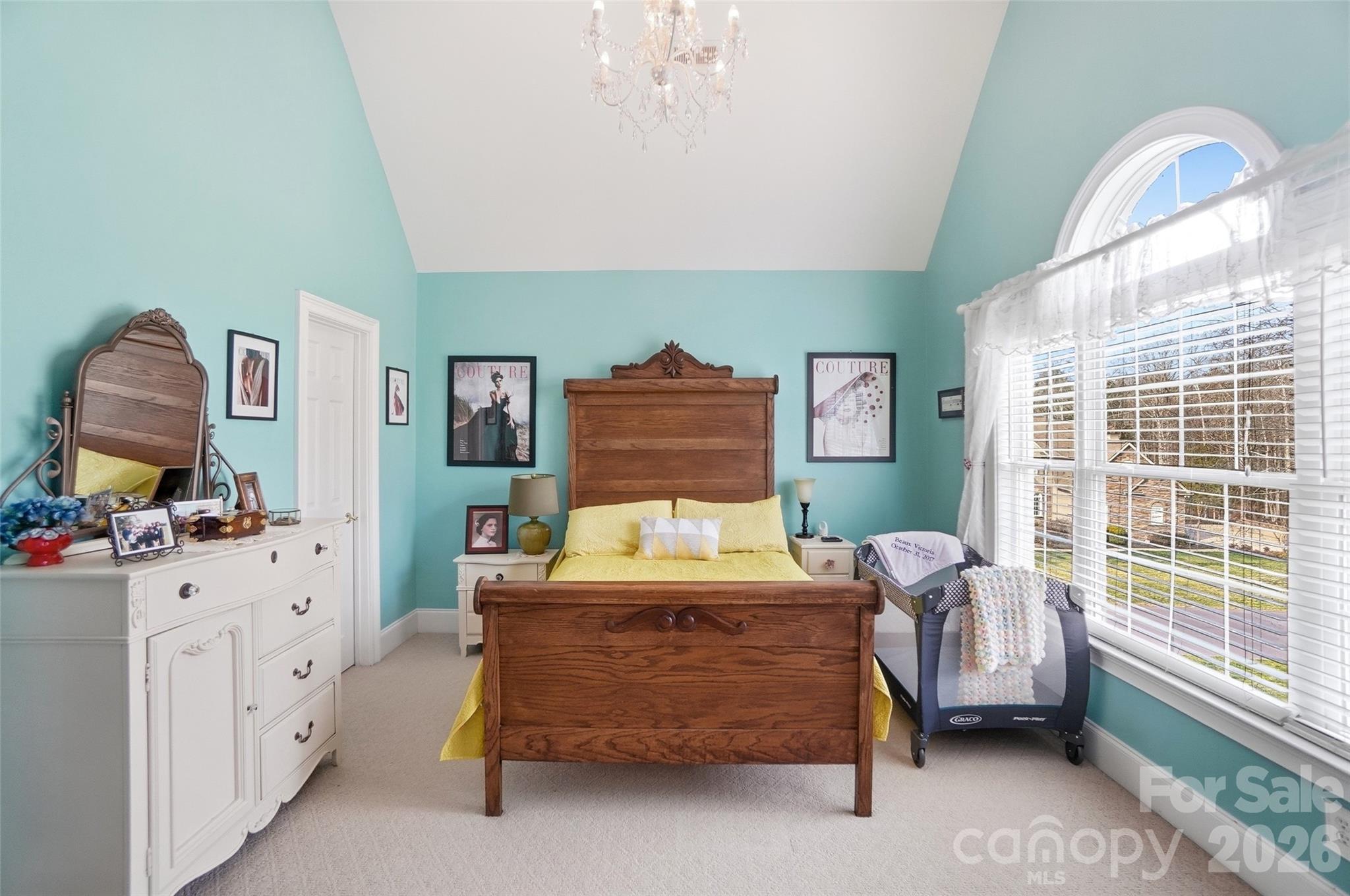 704 Mayfield Court Fort Mill, SC 29715 - Photo 29 of 48 a bedroom with a bed and a chandelier