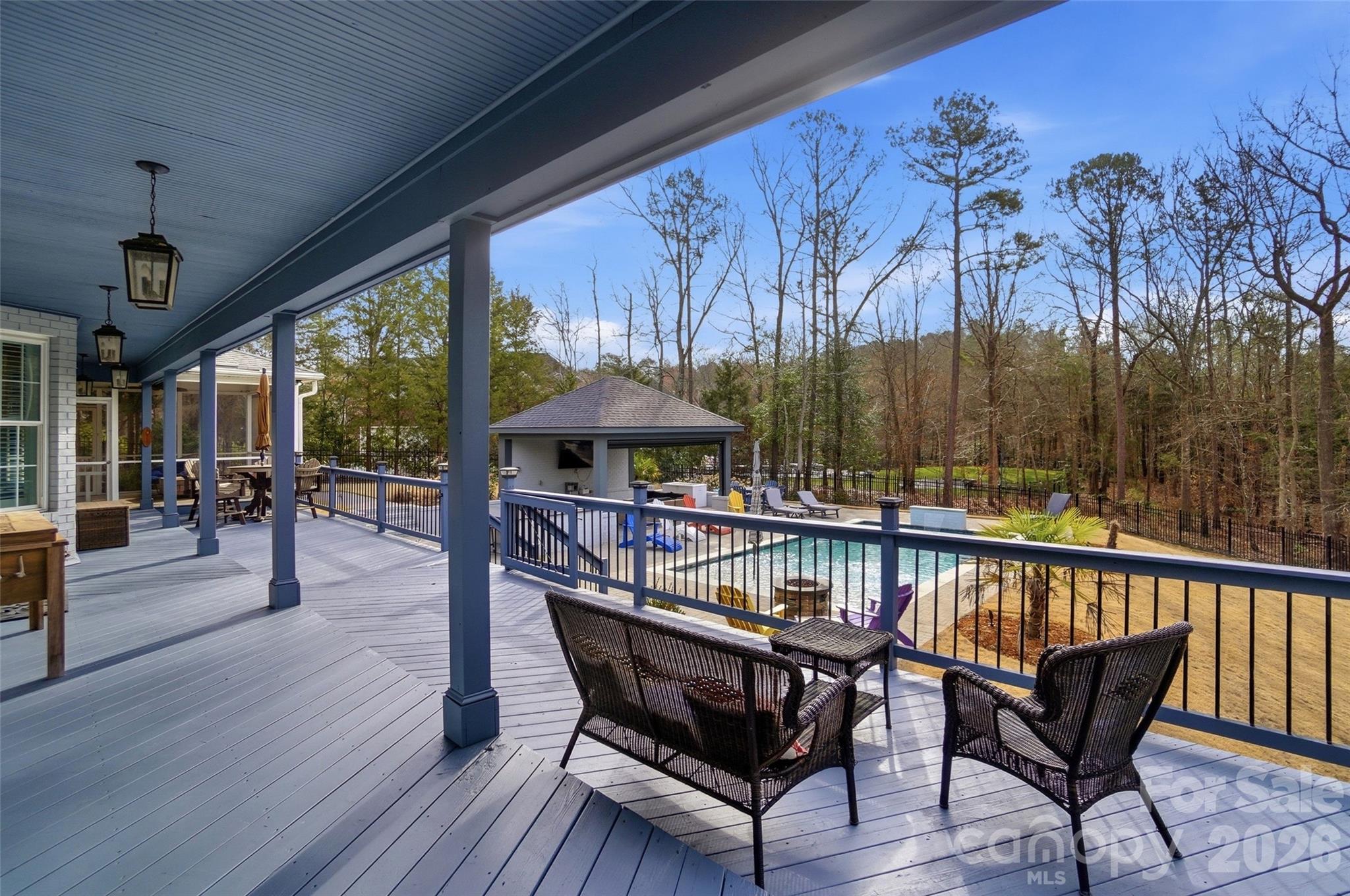 704 Mayfield Court Fort Mill, SC 29715 - Photo 37 of 48 a view of a roof deck with table and chairs under an umbrella with wooden floor