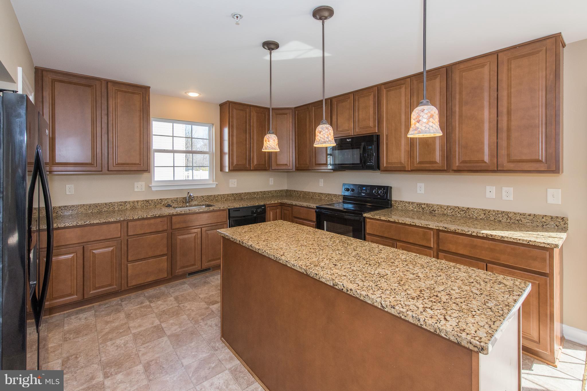 1005 Wampler Road Baltimore, MD 21220 - Photo 12 of 30 a kitchen with a sink a counter top space cabinets and stainless steel appliances